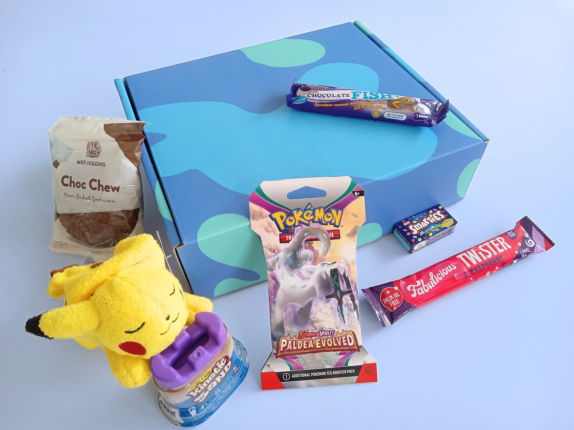 Pokemon kids gift box, containing Pokemon plushie, Pokemon Booster pack, twister and chocolate fish