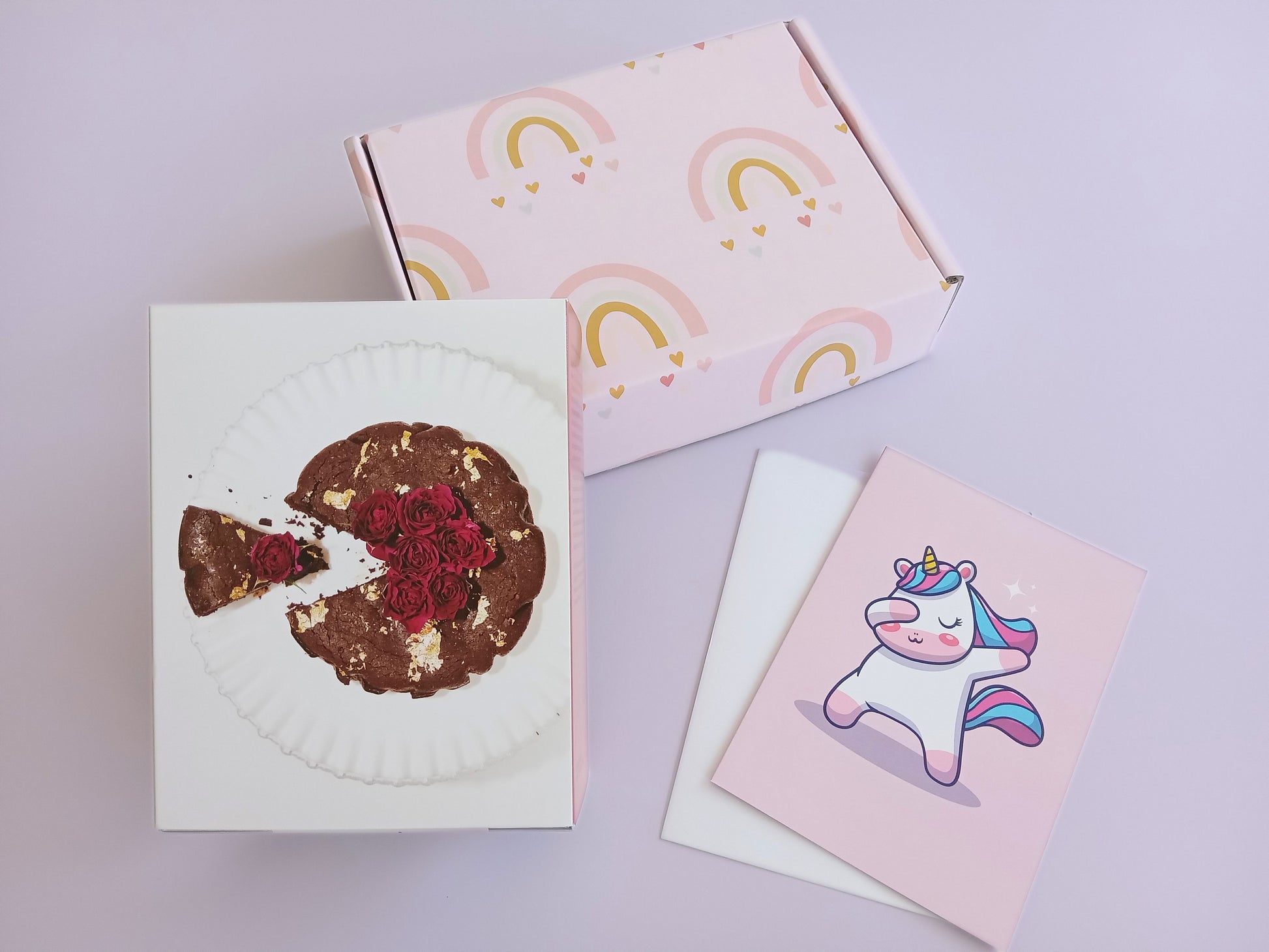Gift box for kids, pink design containing The Caker cake kit. Light pink and rainbows box design